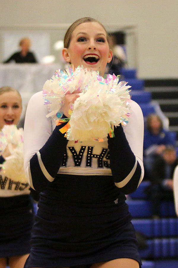 Smiling to the crowd during the pom routine, sophomore Kenzie Harris performs at the Kansas City Classic on Saturday, Dec. 8.