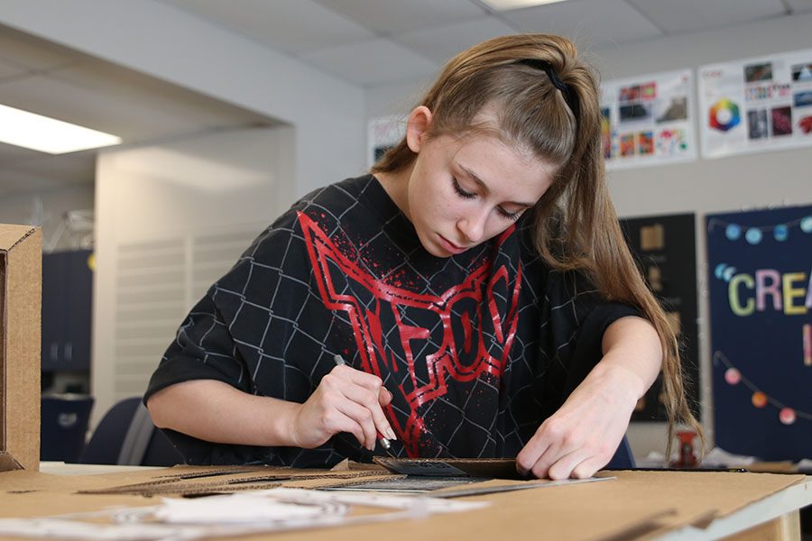 With an Exacto knife in hand, junior Megan Krown works on her sculpture project on Tuesday, Nov. 27.  