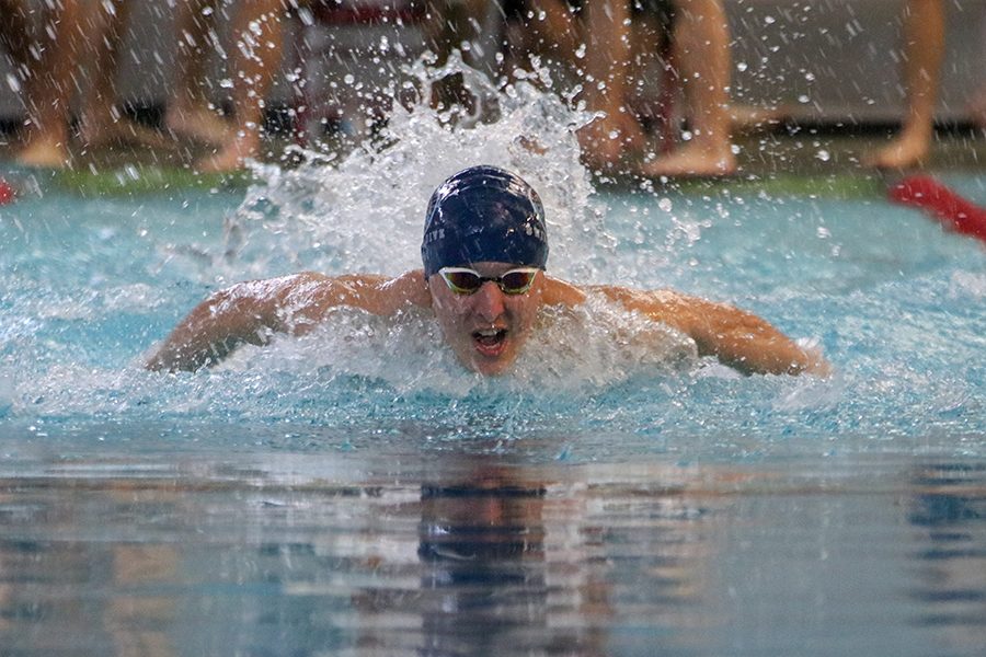Coming down his lane, junior Colby Beggs competes in the 200-yard butterfly relay at the Lansing Relays on Saturday, Dec. 1. I feel like the meet went really well, we grew as a team said Beggs [Personally] I could improve on my pacing during my 200 [freestyle]   