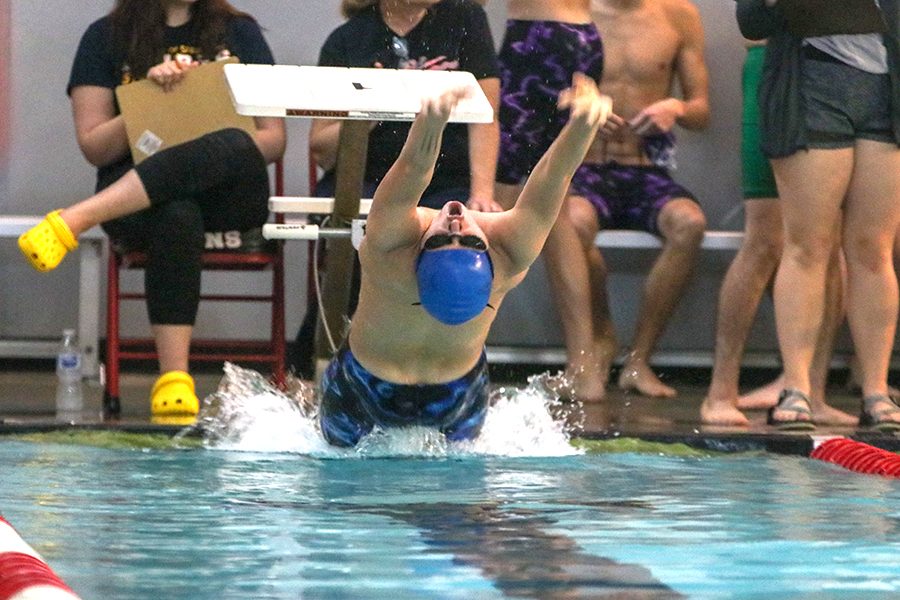 To start of the 100-yard medley relay, junior Noah Collins pushes off the wall for the backstroke.  