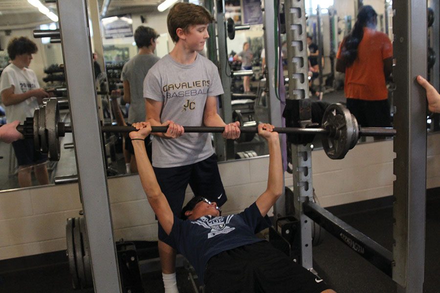 While maxing out in strength on Thursday, Nov 29, freshman Aidan Jacobs helps freshman Blake Boatwright rack the bar.