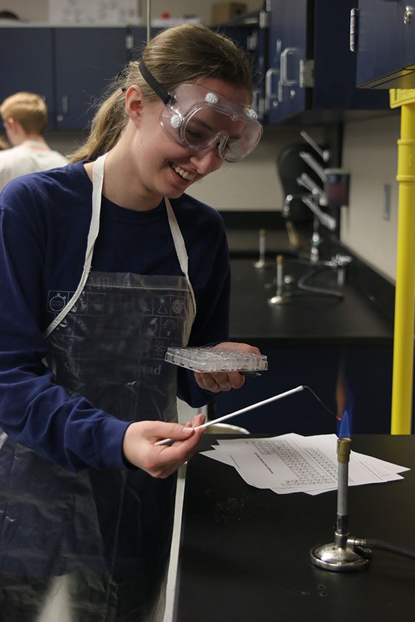Holding a chemical to the bunsen burner in ‘Forensics,’ senior Liz Fraka tries to identify the unknown powder.