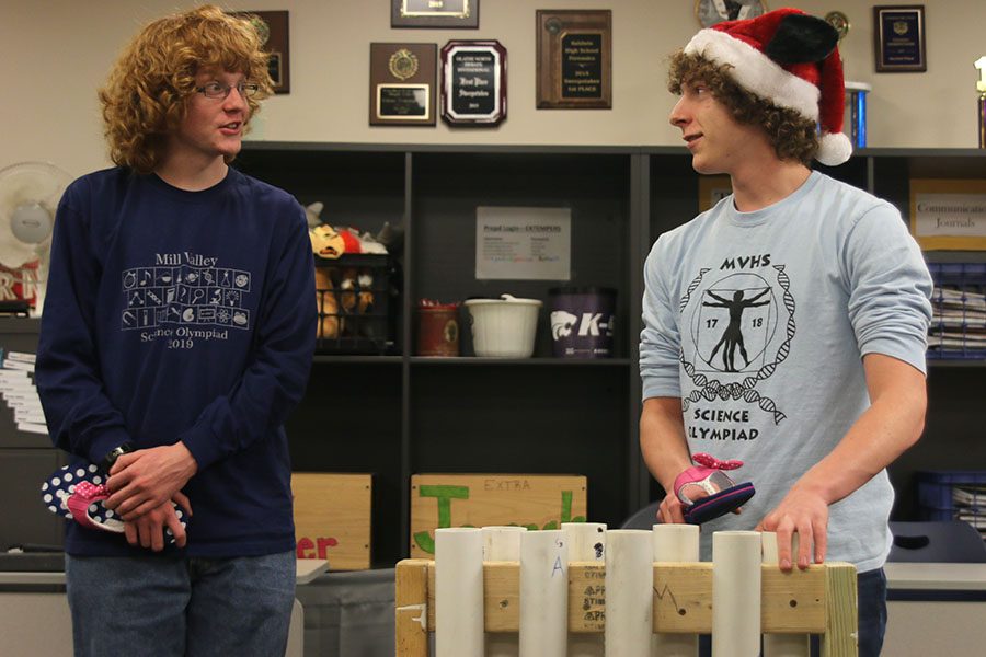 Turning to partner junior Griffin Schenk, junior Logan Oesterreich prepares to hit a PVC pipe with a flip flop to create a sound for the Sounds of Music event.