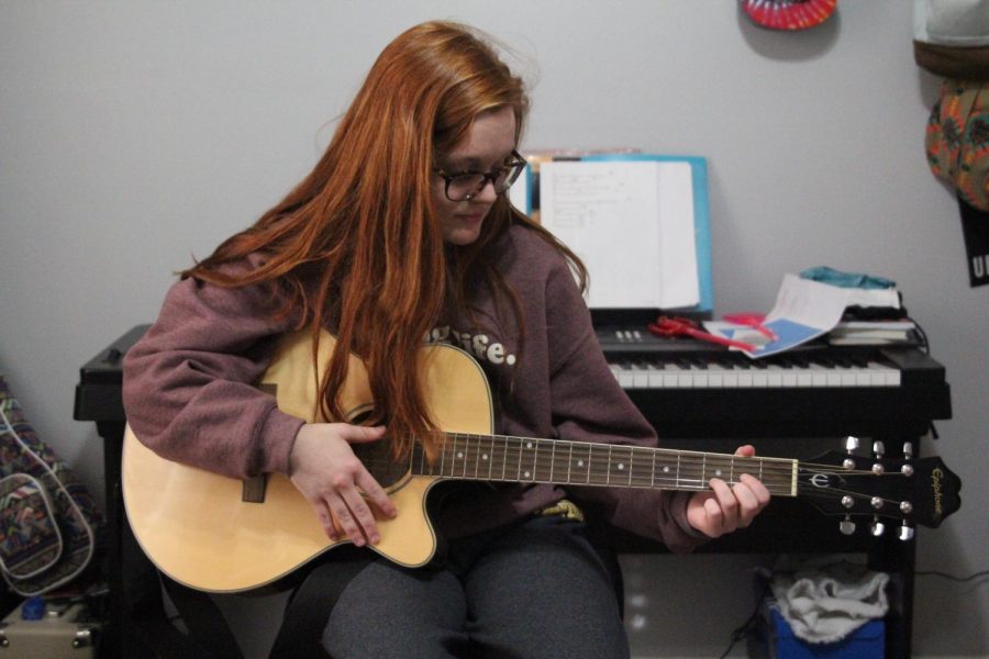 Strumming her guitar, junior Meghan Sherman practices the song “Make You Feel My Love” for her ‘The Voice’ audition.