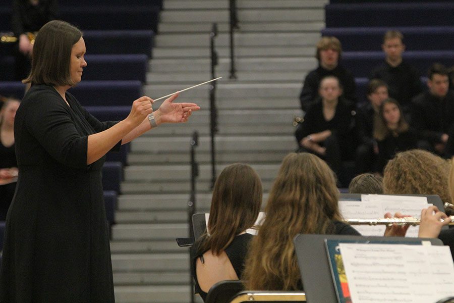 Band+director+Debra+Steiner+conducts+the+band+as+they+perform+for+the+crowd.