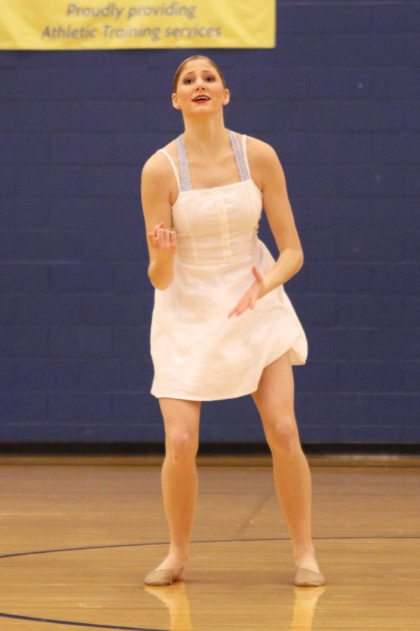 Reaching out, senior Addie Ward shows emotion during her solo performance, making the circle of winners at Miss Kansas on Sunday, Jan. 20.