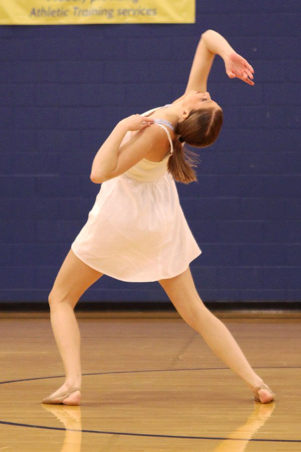 Leaning back, senior Addie Ward performs her solo routine, making the circle of winners at Miss Kansas on Sunday, Jan. 20.