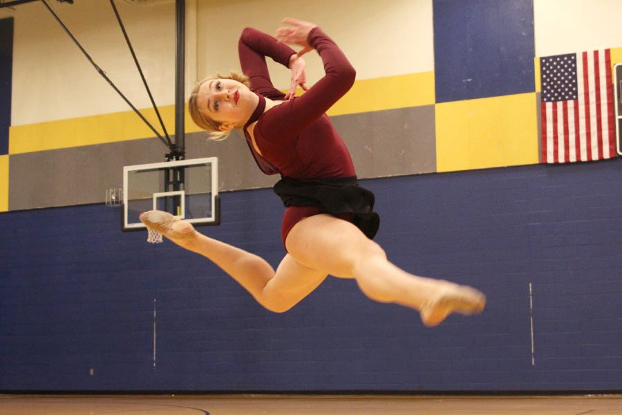 Leaping in the air, junior Sydney Ebner performs her solo, making the circle of winners at Miss Kansas on Sunday, Jan. 20.