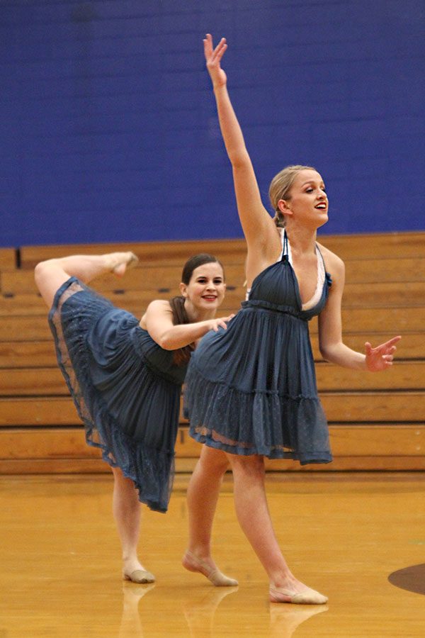 Holding onto her waist, senior Olivia Augustine performs a duo routine with senior Bella Line, making the circle of winners at Miss Kansas on Sunday, Jan. 20.