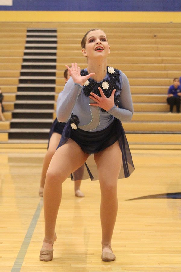 Reaching one arm out, sophomore Tyler Bret dances in the jazz routine, which received the Outstanding Choreography award at Miss Kansas on Monday, Jan. 21.