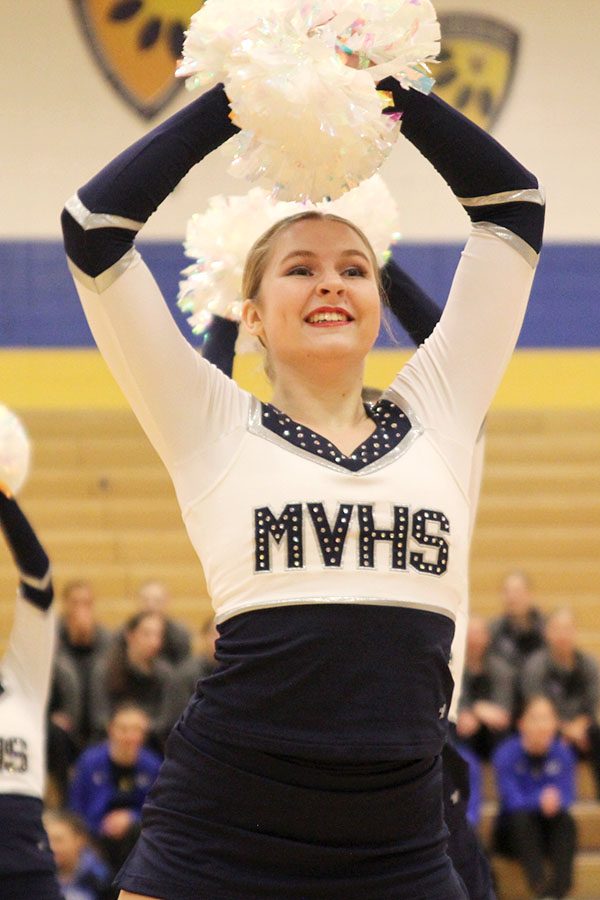 Poms above head, junior Sydney Ebner dances in the pom routine, which received the Polish and Precision award at Miss Kansas on Monday, Jan. 21.