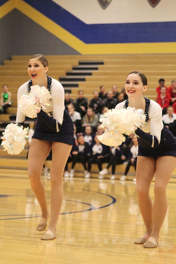 Shaking their poms together, senior Addie Ward and sophomore Lauren Acree perform in the pom routine, which received the Polish and Precision award at Miss Kansas on Monday, Jan. 21.