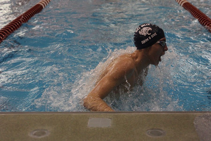 Making a turn, sophomore Cole McClure swims in the 200 yard medley relay.