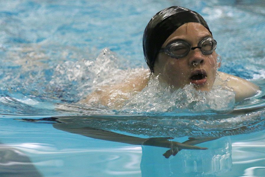 Breathing between strokes, freshman Walker Lenon finishes up the first 25 yards of his breaststroke in the 200-meter individual medley. 