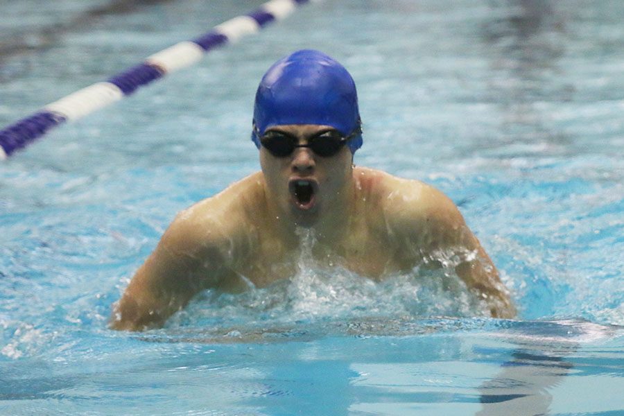 Beginning the butterfly 50-yard portion of the 200-meter individual medley race, sophomore Noah Collins emerges out of the water for another stroke. 