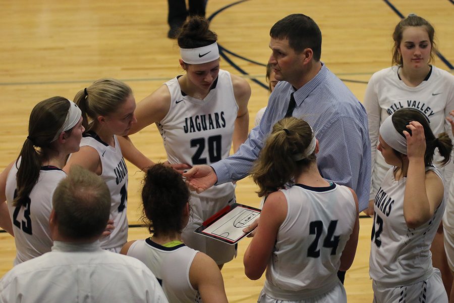 During a timeout in third quarter, head coach Drew Walters draws out a play.