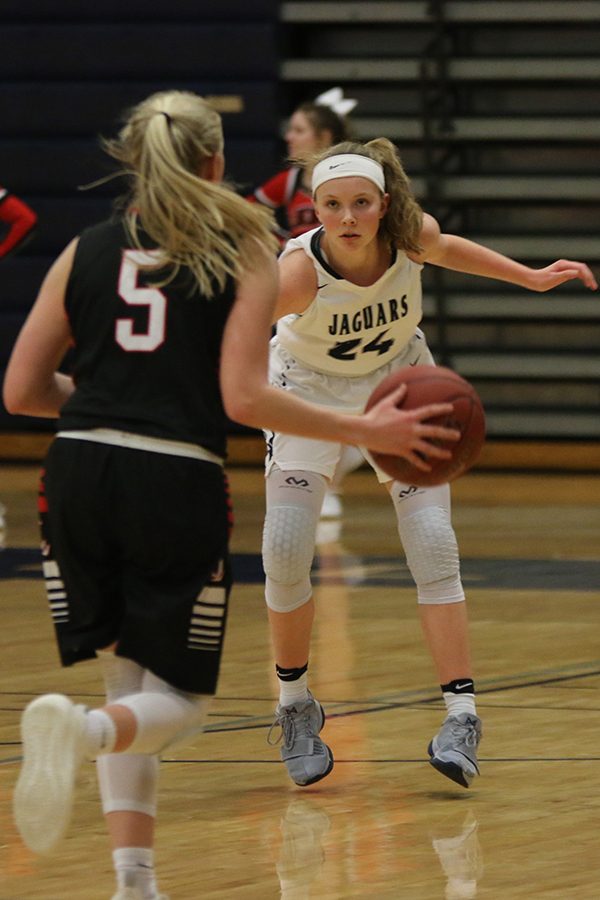 Arms out, freshman Emree Zars prevents her opponent from making a basket.