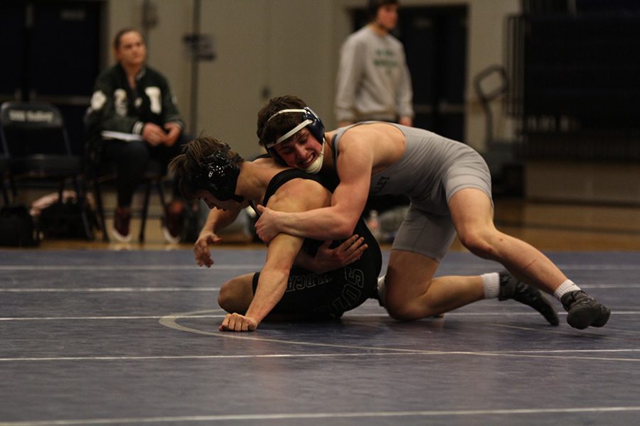 In the middle of the mat, junior Chase Cline tries his best to get his opponent on his back.