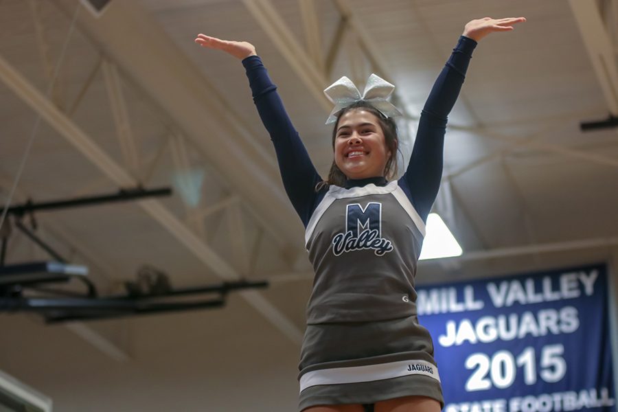 During team introductions, senior Mya Johnson waves towards the crowd.  