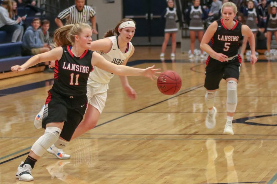 After a Lansing player loses control of the ball, senior Claire Kaifes tries to get the ball. 