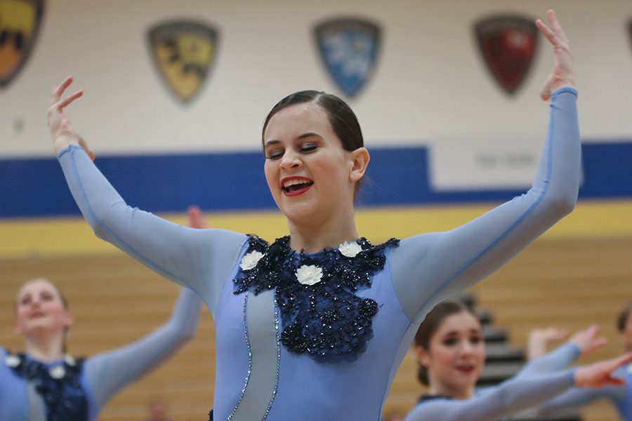 Throwing her arms in the air, senior Olivia Augustine looks down towards the ground at the Miss Kansas dance competition held at Olathe South High School on Sunday, Jan. 20 and Monday, Jan. 21.