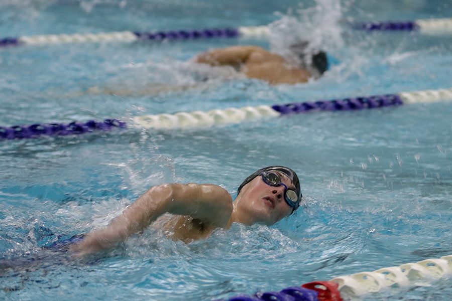 Swimming on his side, freshman Ryan Biven takes a breath of air. 