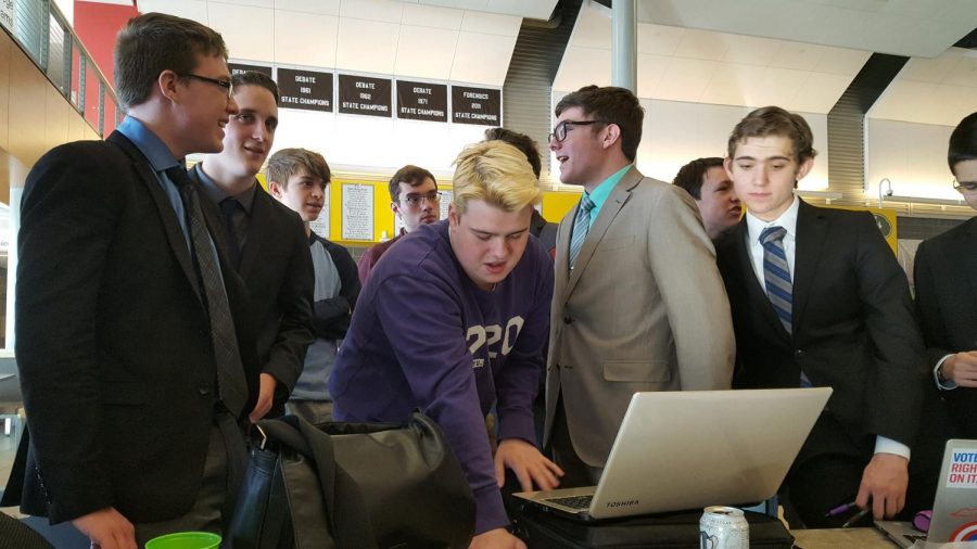 Pulling up BLANK, Debate assistant coach and alumni Jack Booth helps the team prepare for the next round. 