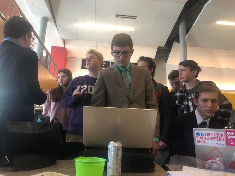 Looking at his laptop, sophomore Zachary Botkin reads over his speech before going to his round.
