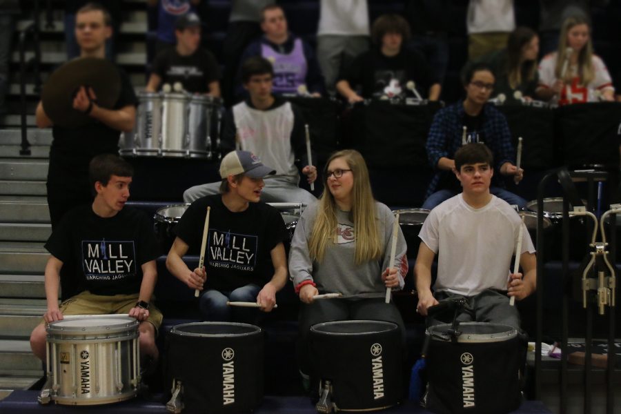 In order to hype up the crowd, the drumline performs a song during a time out.