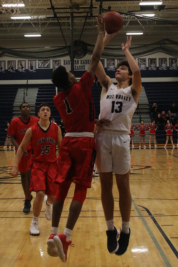 Jumping into the air, sophomore Pete Janssen avoids a block during the second half of the game.