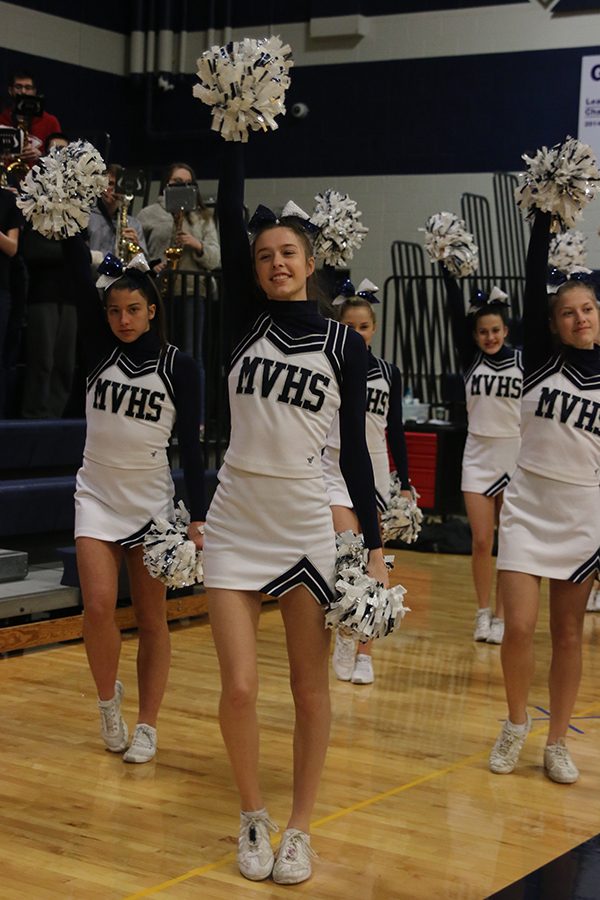 Closing the game, senior Erin Miller cheers to the fight song.