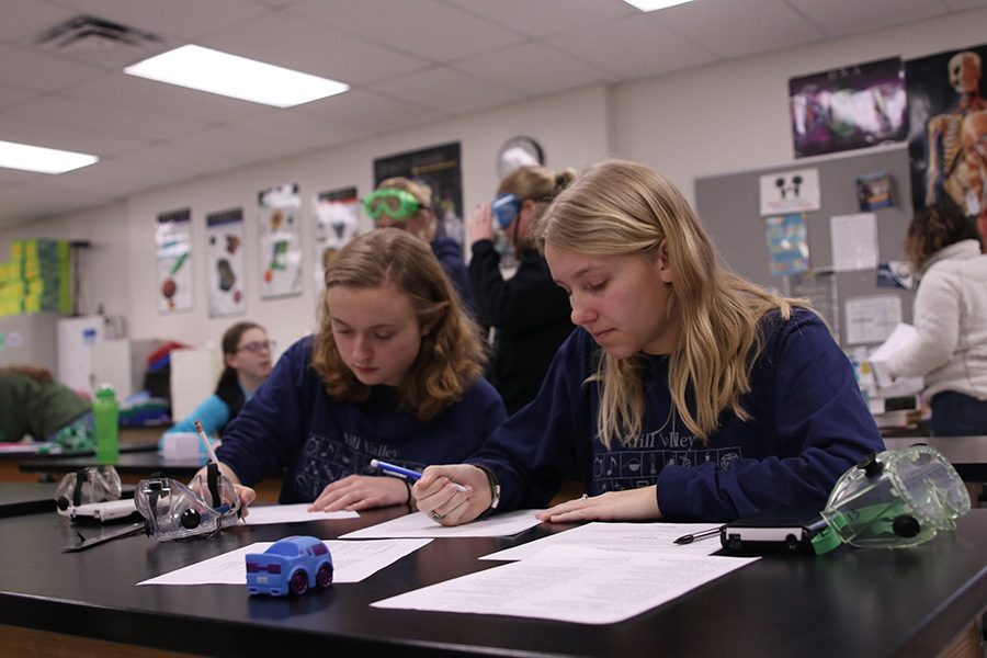 While competing in the experimental design event, senior Sydney Clarkin and junior Callie Roberts begin to write on their papers.