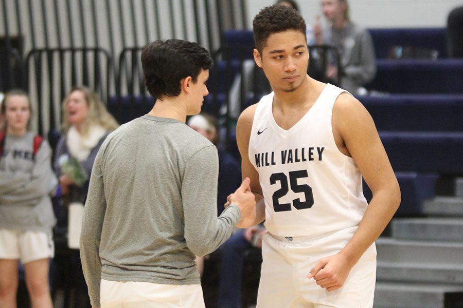 Doing a hand shake senior Seth Hobson starts the game with junior Brayden Whisler.