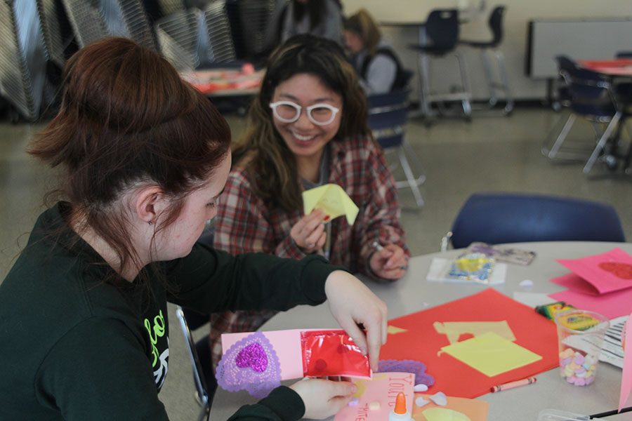 Folding origami, senior Libby Mullican shows off her paper dog. 