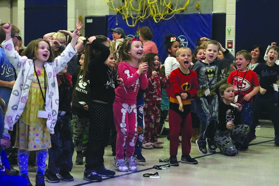 During the last round of heads or tails, elementary school students jump  with excitement and yell as senior Payton Totzke calls heads.