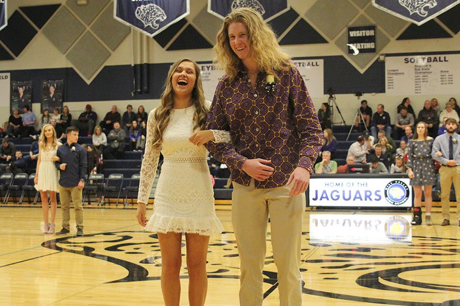 Laughing as they try and hook arms, senior WOCO candidates Ashton Rider and Killian O'Brien meet at center court.