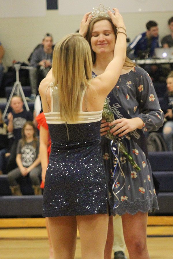 After being pronounced WOCO queen, senior Claire Kaifes receives her crown from senior Bella Line.