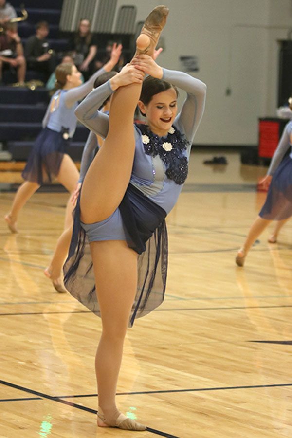 Performing the same dance they did at nationals, senior Olivia Augustine and the rest of the Silver Stars raise their legs in the air.