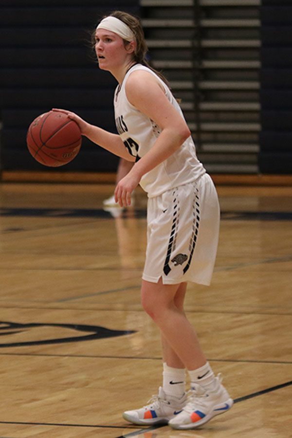 After rebounding the ball, senior Claire Kaifes looks down court to find an open teammate.
