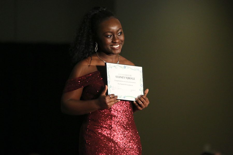After receiving a scholarship from the Natalie M. Foundation, senior Sydney Njoroge smiles.