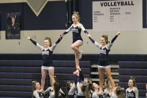 As their last move for the De Soto Cheer Showcase on Monday, Feb. 25, the cheer team performs a stunt.