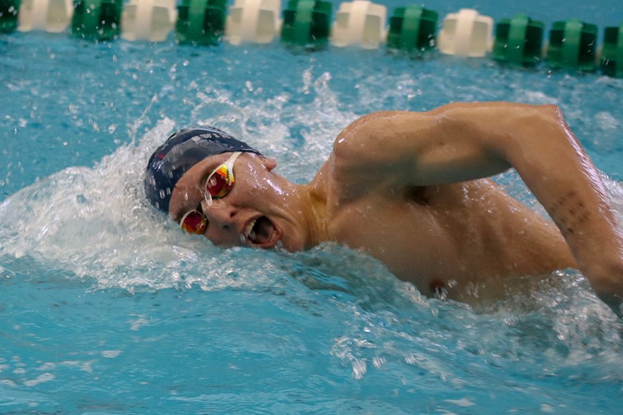 In the 400 Yard Freestyle Relay, junior Colby Beggs comes up for air in the middle of his stroke. 