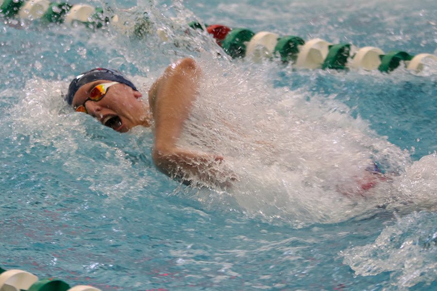 Bringing his arms forward, junior Colby Beggs competes in the 200 Yard Medley Relay. 