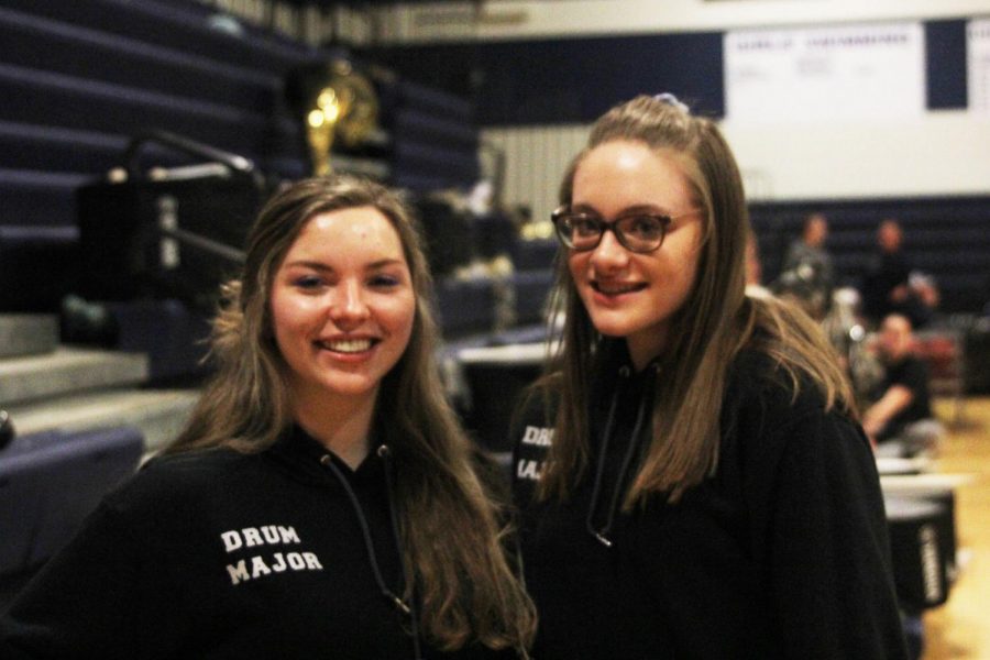 Junior drum majors Kaleigh Johnston and Amber Guilfoil stand in front of the band section during the girls basketball game on Thursday, Feb. 21