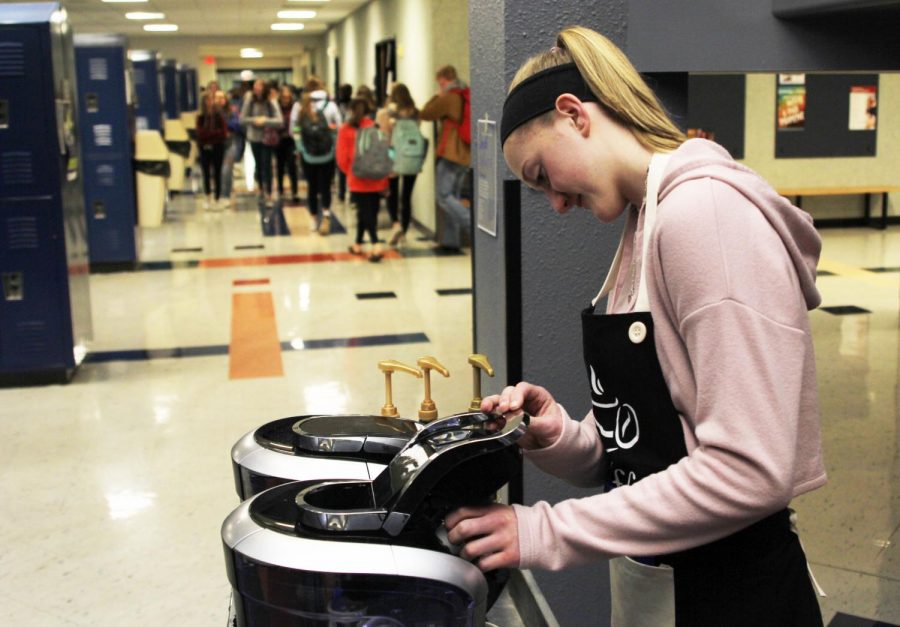 Preparing for the typical morning rush, senior Ally Appl places a Keurig K-Cup into the coffee maker on Tuesday, Jan. 22. “Usually we get a lot of business and sell a lot of coffee,” Appl said.
