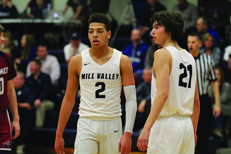 In the first half of the game, senior Matthew Wittenauer stands with sophomore Peter Janssen.
