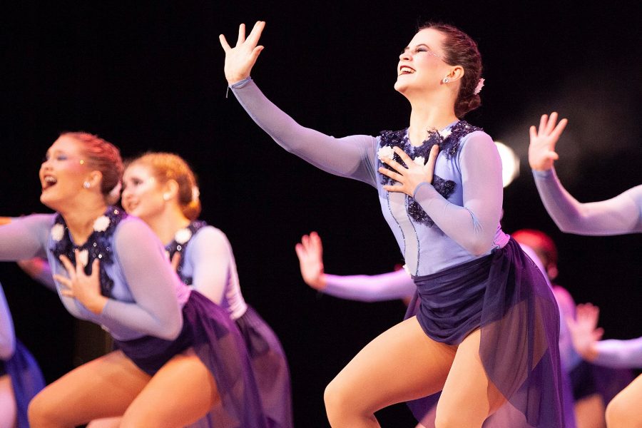While performing a jazz routine, senior Olivia Augustine reaches out to the crowd.