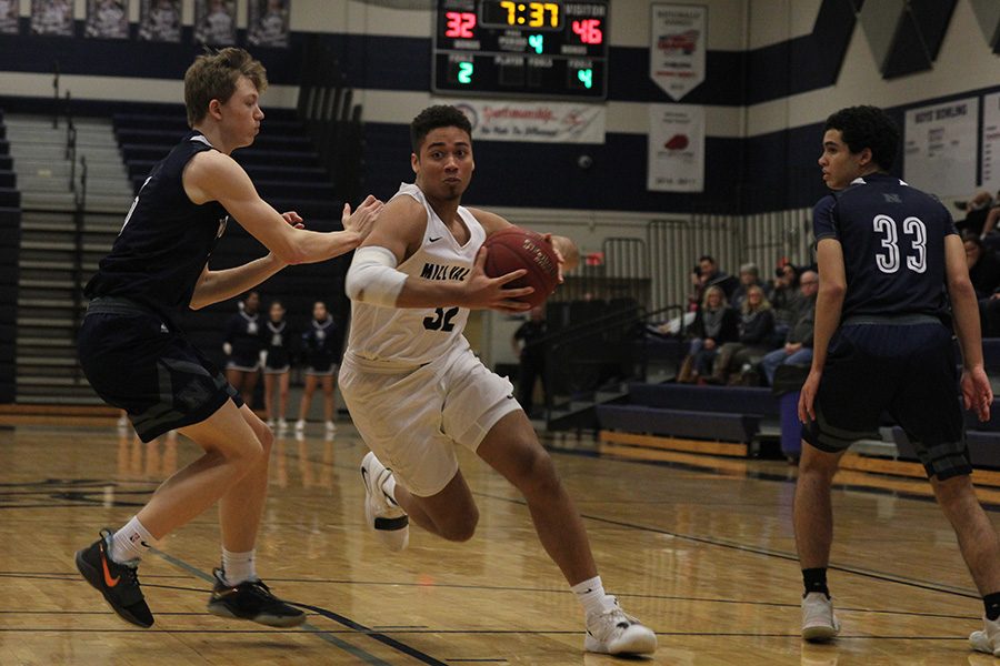 Focused on scoring a basket, senior Seth Hobson advances down the court on Thursday, Feb. 21. The team fell short against BVN on senior night with a score of 66-48