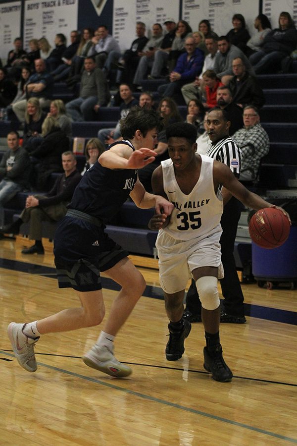 As a BVN opponent applies pressure, senior Trey Dameron maintains possession of the ball.