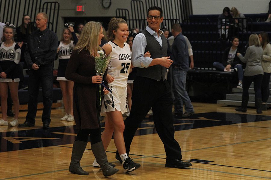 As she is introduced for senior night, senior Shyanne Best walks out with her parents.